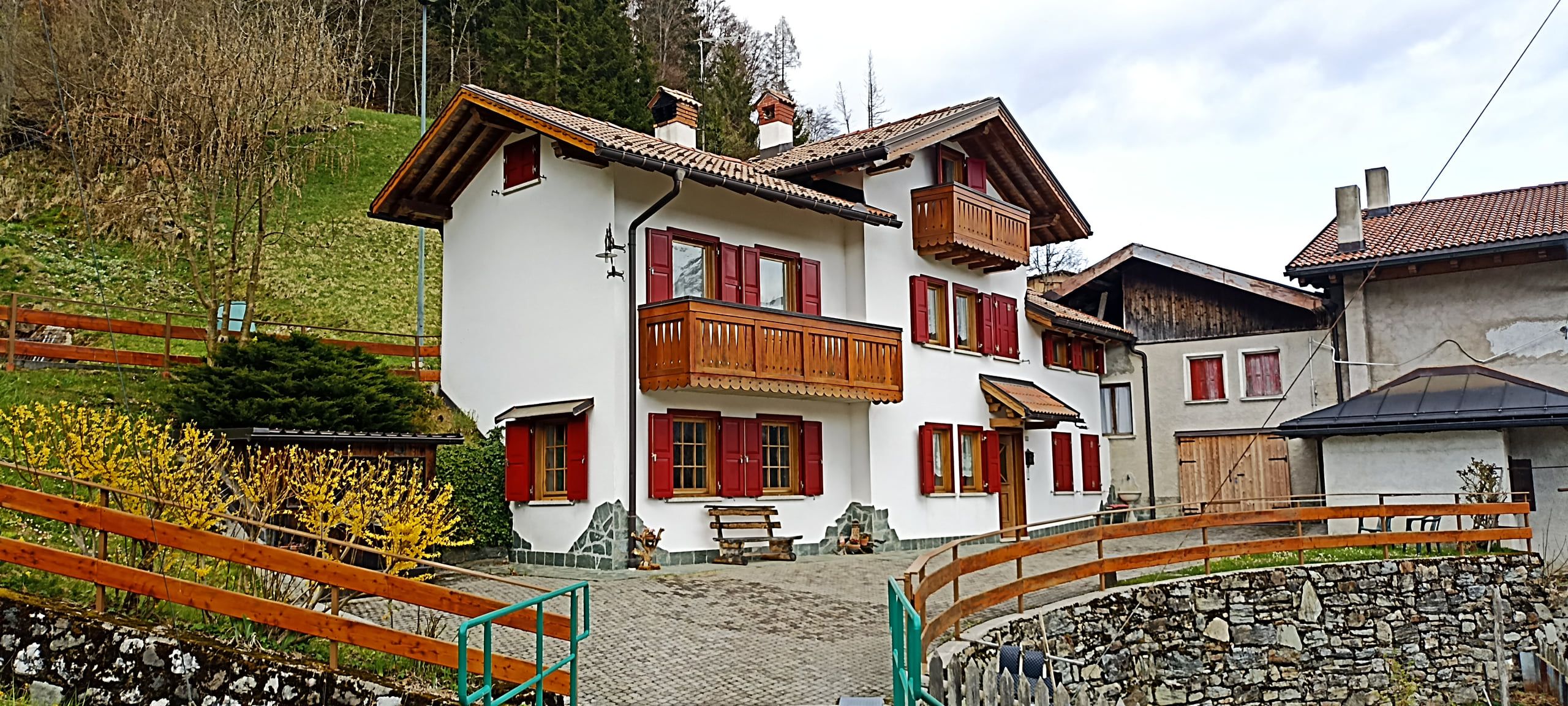 Casa da Olly vista da fuori, con i prati e i boschi attorno